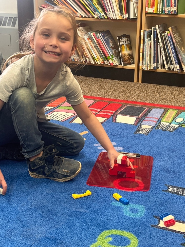 girl building a Lego bridge 